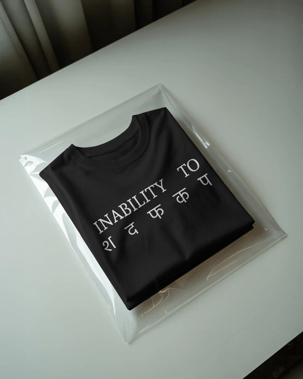 Black STFU graphic t-shirt packaged